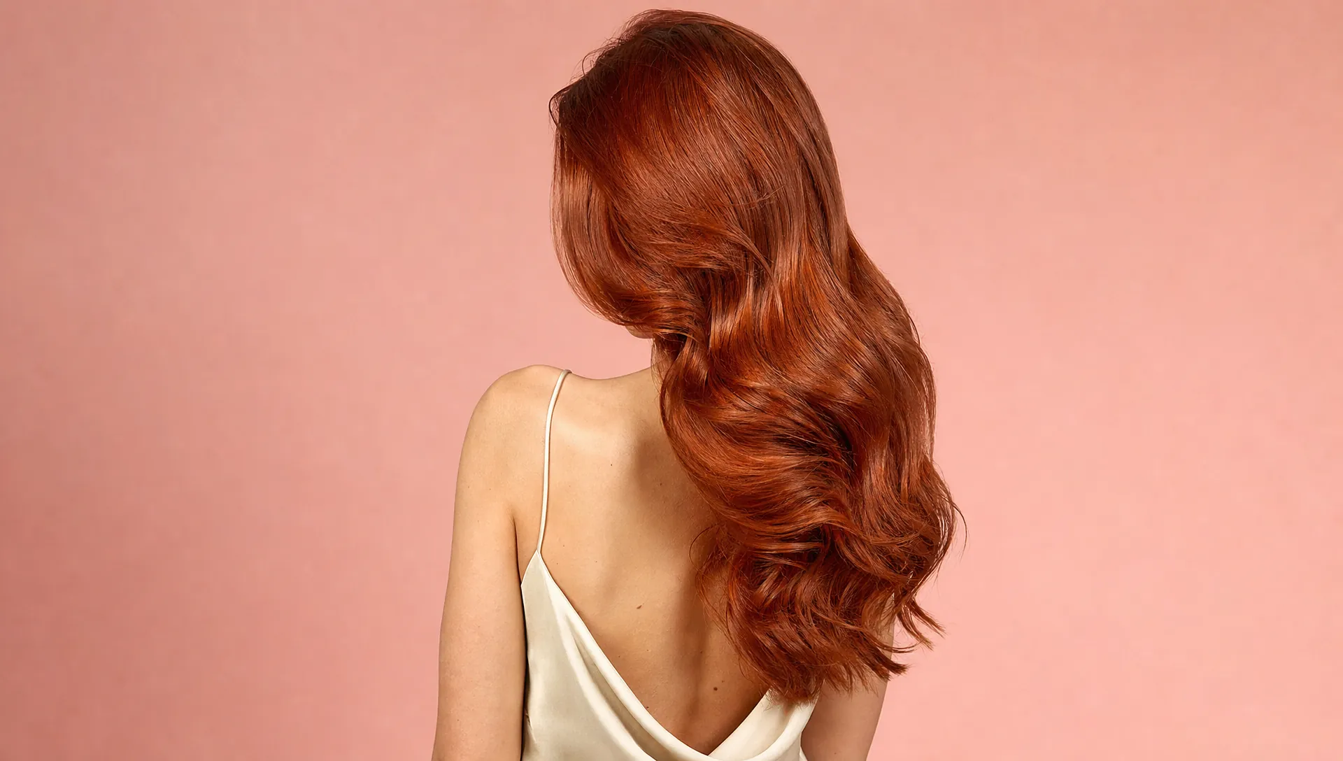 Glossy copper waves against a blush studio backdrop